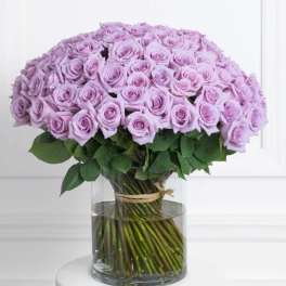 Lavender rose bouquet in a clear glass vase