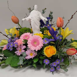 Colorful floral arrangement with a white statue centerpiece