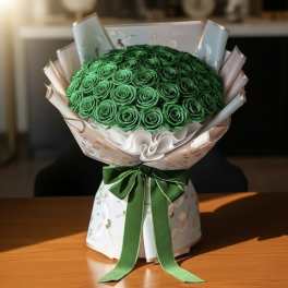 Bouquet of green roses wrapped in pastel paper with a green ribbon
