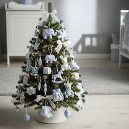 Small Christmas tree decorated with blue baby ornaments and white ribbons