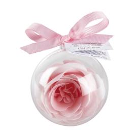 Pink rose-shaped ornament in a clear round container with a ribbon bow