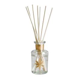 Glass reed diffuser bottle with cream-colored reeds