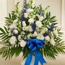 White and blue floral standing spray with a blue ribbon