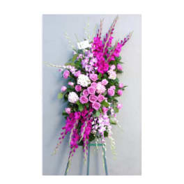 Tall pink and white floral standing spray on a metal easel