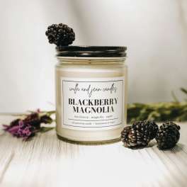 Blackberry Magnolia candle in a glass jar with blackberry decorations