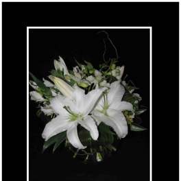 White lily bouquet in a clear vase
