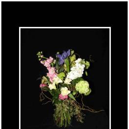Tall mixed bouquet with pink, white, green, and purple flowers in a vase