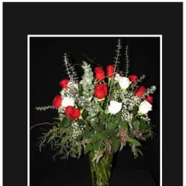 Red and white roses in a clear glass vase