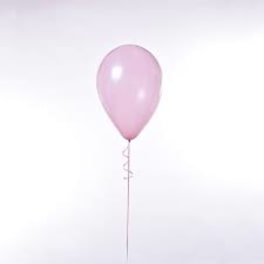 Single pink balloon on a stick against a white background