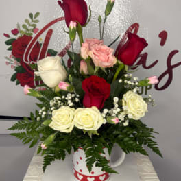 Mixed rose bouquet in a white mug with red hearts