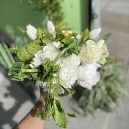 White bouquet with roses, ranunculus, and tulips
