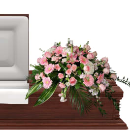 Pink floral casket spray with roses and daisies