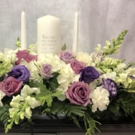 Lavender and white floral casket spray with candles