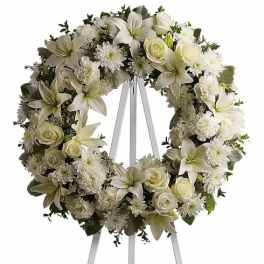 White floral wreath on a standing easel