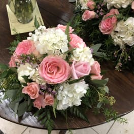Pink roses and white hydrangeas arranged on a table