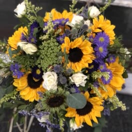 Bouquet of sunflowers, white roses, and purple asters