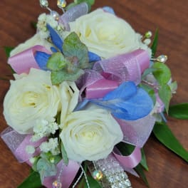 White rose bouquet with pink and blue ribbons and crystal accents