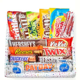 Assorted candy bars and sweets arranged in a gift basket
