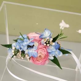 Pink and blue floral wrist corsage with white ribbon