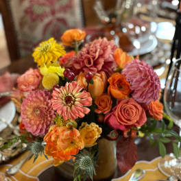Colorful bouquet of roses, dahlias, and mums in a vase