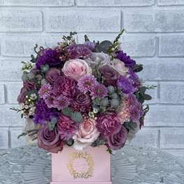 Pink and purple bouquet in a pink box