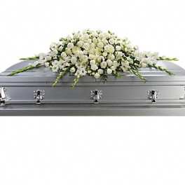 White floral spray on a silver casket