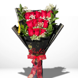 Bouquet of red roses with white baby's breath in black wrap and red ribbon