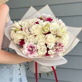 Bouquet of cream and pink flowers wrapped in white paper