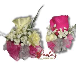 Two small rose bouquets wrapped in pink and silver ribbon