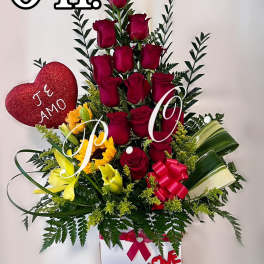 Tall bouquet of red roses and yellow lilies with a heart decoration in a white box