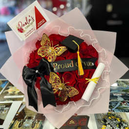 Red rose bouquet with a graduation cap, diploma, and black ribbon