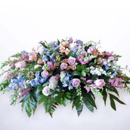 Large pastel floral spray with pink and lavender roses and blue flowers