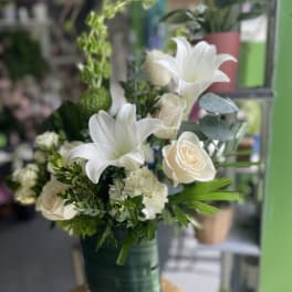 White lilies and cream roses in a green vase