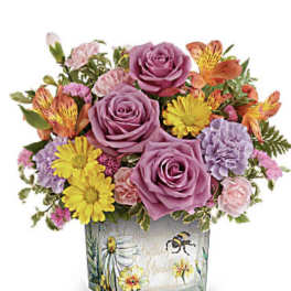 Bouquet of purple roses, yellow daisies, and pink carnations in a painted glass vase