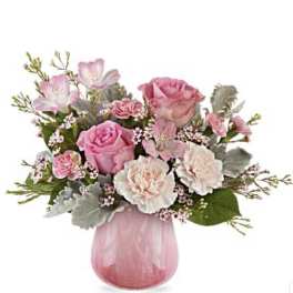 Pink and white flower arrangement in a pink glass vase