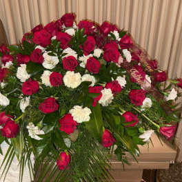 Large red rose and white carnation funeral spray with ribbon