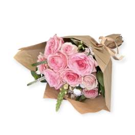 Pink rose bouquet wrapped in brown paper