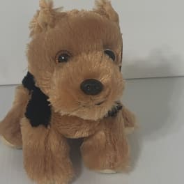 Small brown plush dog toy with black accents