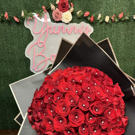 Large bouquet of red roses wrapped in black paper