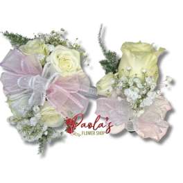 Two small bouquets of cream roses with pink ribbon bows