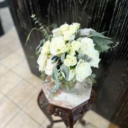 White rose bouquet with eucalyptus in a glass vase