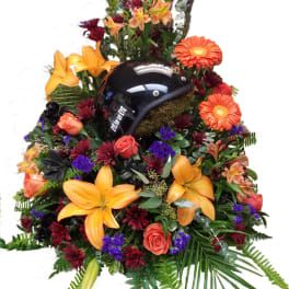 Floral arrangement with a black motorcycle helmet in the center