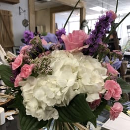 Bouquet of white hydrangeas with pink and purple flowers