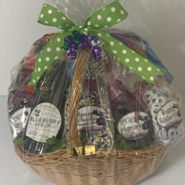 Gift basket with assorted jars and a green polka-dot bow