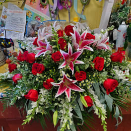Large bouquet of red roses and pink lilies with white filler flowers