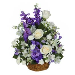 White roses and purple flowers in a wicker basket