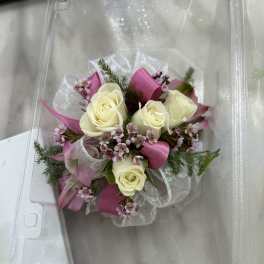 Small bouquet of cream roses and pink filler flowers with ribbon