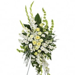 Standing floral spray of white and pale yellow flowers on an easel