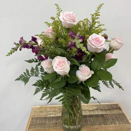 Pink roses and purple snapdragons in a glass vase