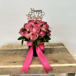 Pink rose bouquet in a black box with a birthday topper and ribbon